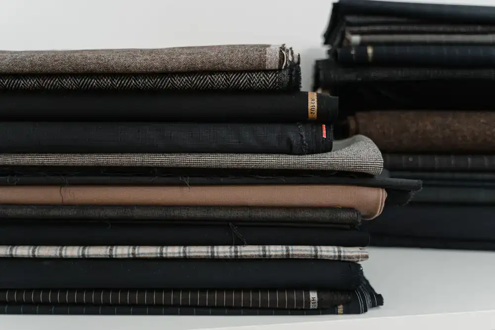 Stack of fabric swatches and tailoring chalk