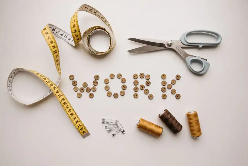 Tailor shop workbench featuring spools of thread and shears
